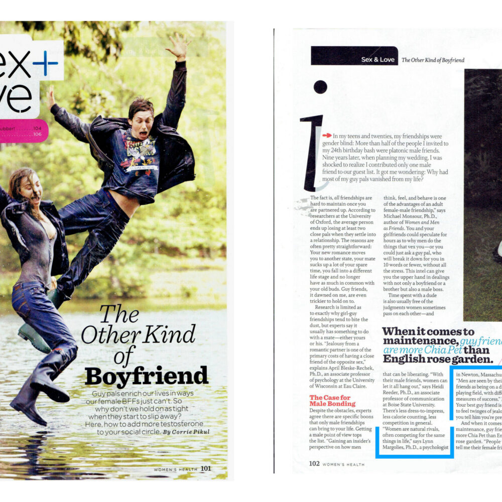 Two people jump joyfully near a lake, illustrating friendship and connection in a magazine article about platonic relationships.
